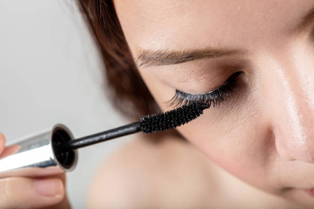 istock Woman applying black mascara on eyelashes with makeup brush 648085078
