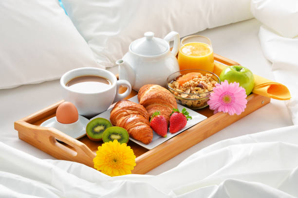 istock Breakfast tray in bed in hotel room 648087582
