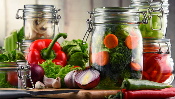 istock Jars with marinated food and raw vegetables on cutting board 648091482