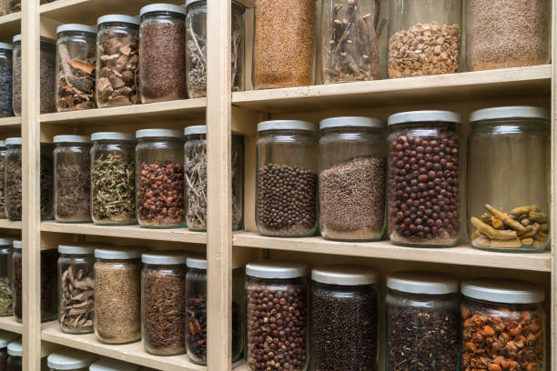 istock Glass bottles with colorful spices on the shelfs 648108700