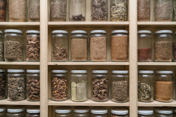 istock Glass bottles with colorful spices on the shelfs 648109364