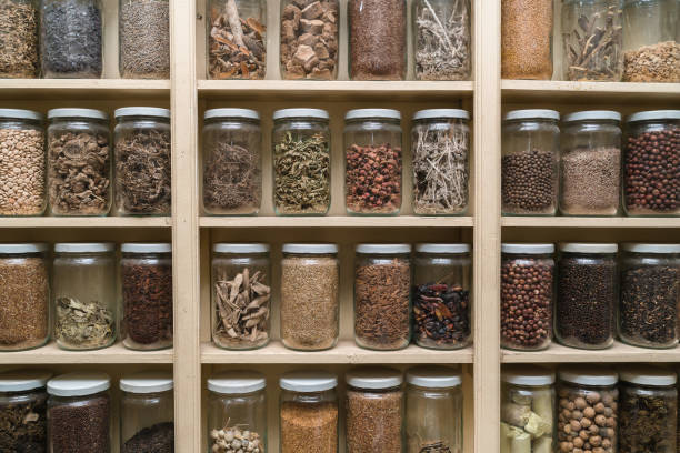 istock Glass bottles with colorful spices on the shelfs 648111768