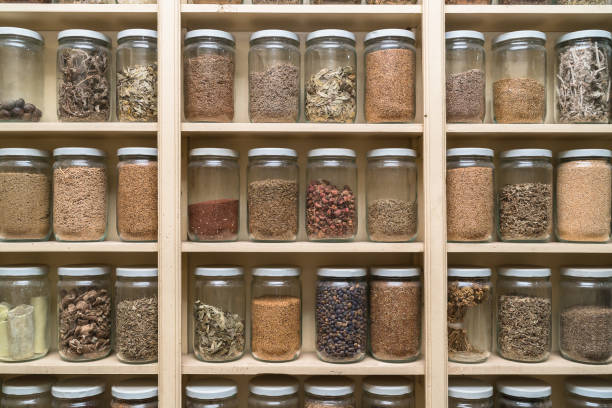 istock Glass bottles with colorful spices on the shelfs 648112842