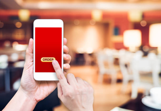 istock Hand holding mobile with order button at blur restaurant background 648113260