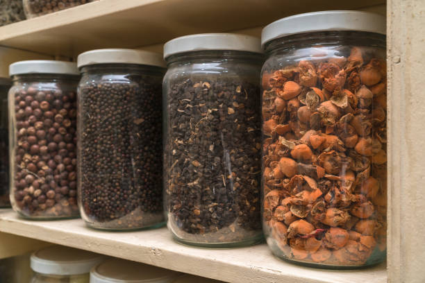istock Glass bottles with colorful spices on the shelfs 648113408