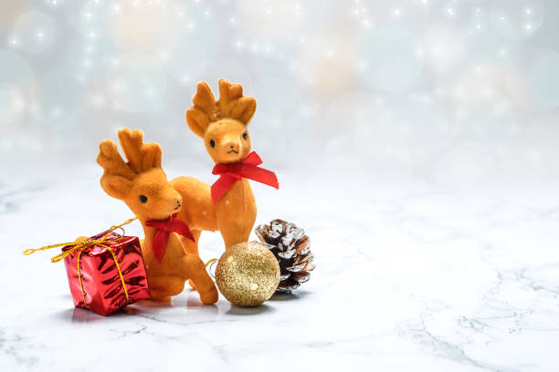 istock Christmas reindeer and gift,pine cone,gold ball on marble 648113626
