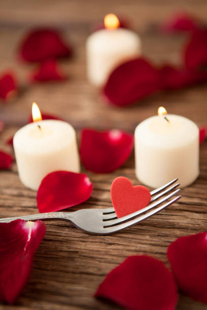 istock Wax candles surrounded with rose petals 648117630