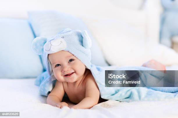 Baby In Towel After Bath In Bed Stock Photo - Download Image Now - Baby - Human Age, Newborn, Bathtub