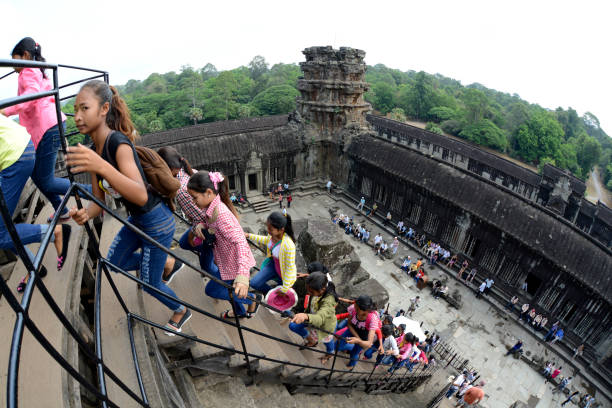 Tourists at the Angkor Wat in the Temple City of Angkor near the City of Siem Riep in the west of Cambodia.