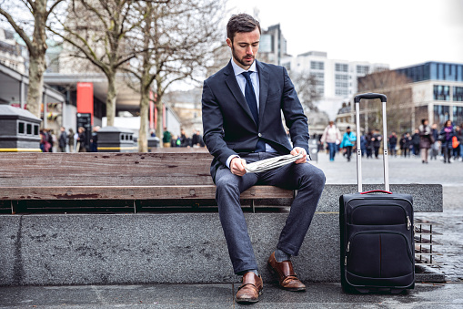 Young 30 years old business man walking in the street of the City of London.