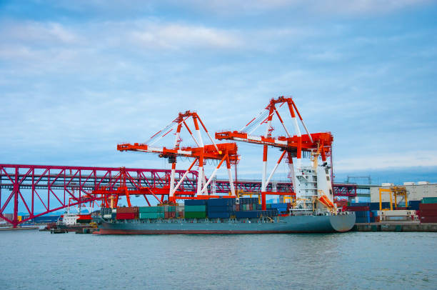 istock Commercial delivery cargo container ship being unloaded in the harbor transportation concept 648138770
