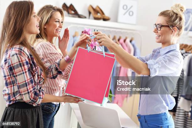 Female Customer Receiving Shopping Bags In Boutique Stock Photo - Download Image Now