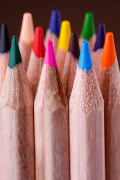 istock group of sharpened colorful pencils on brown background. 648139792