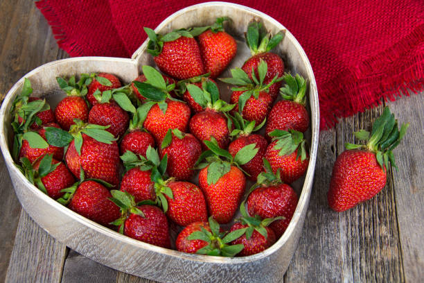 istock whole strawberries in heart dish 648151686