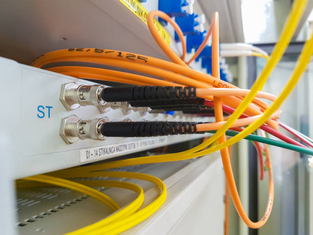 istock Closeup of fiber optic cable plugged into switch. 648154900