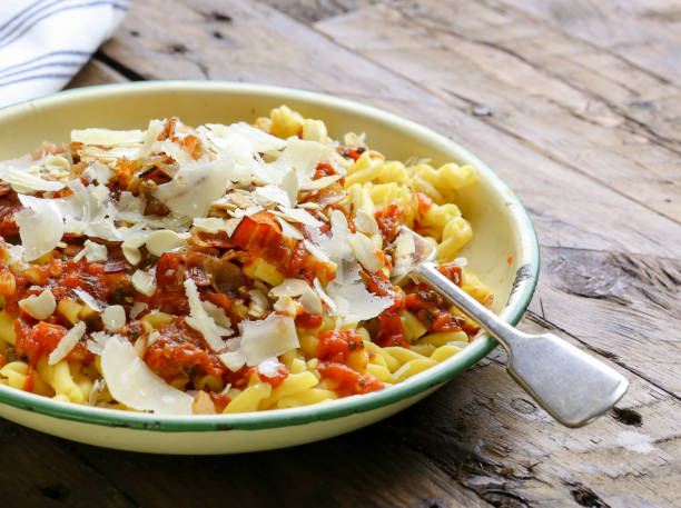 Italian pasta with tomato pancetta almonds and parmesan cheese - fotografia de stock