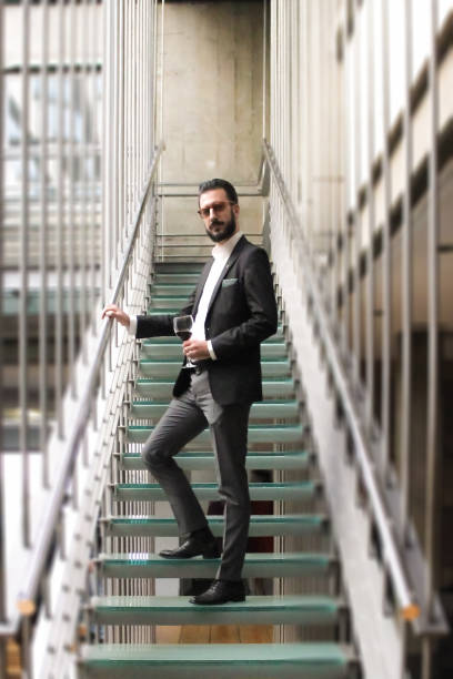 istock Young business man standing on staircase 648182514