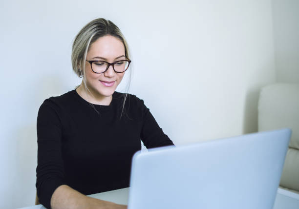 istock Beautiful young woman working with laptop 648192078