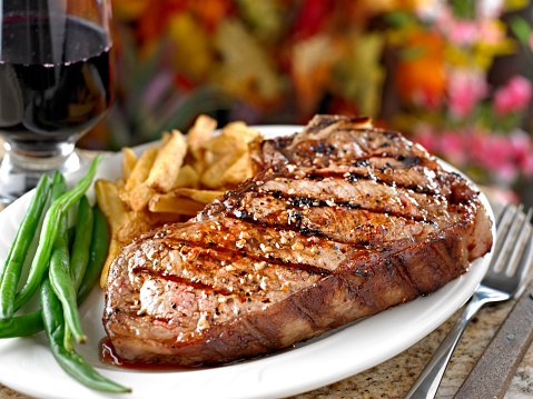 Juicy Grilled New York Steak with French Fries ans roasted green bean