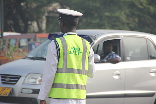 Traffic Scene with a police man and traffic light in Accra, Ghana, West Africa.