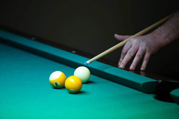 istock Billiard. hand with cue prepare hit a ball 648200374
