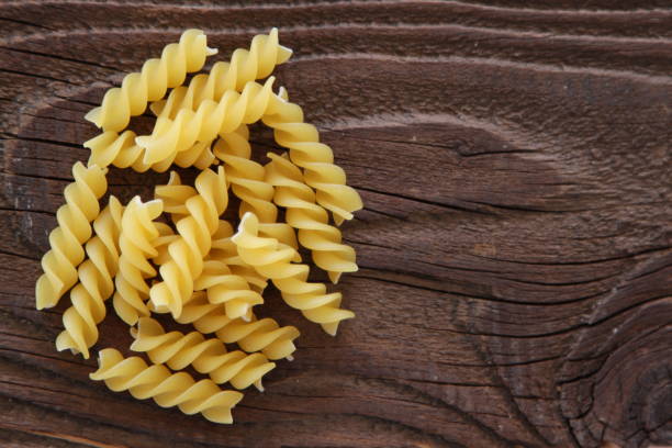 istock Dry Pasta on wooden background 648206032