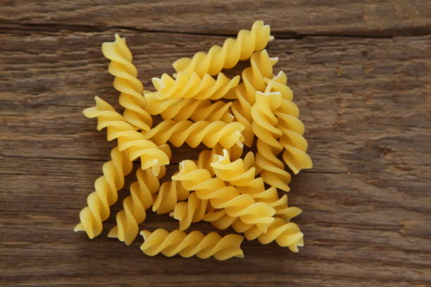 istock Dry Pasta on wooden background 648206040