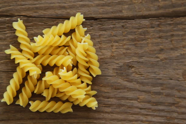 istock Dry Pasta on wooden background 648206042