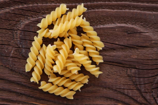 istock Dry Pasta on wooden background 648206044