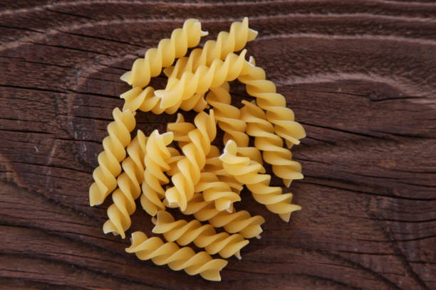 istock Dry Pasta on wooden background 648206060