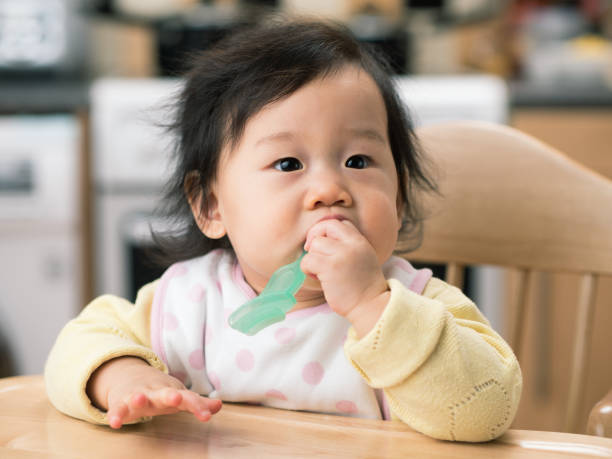 istock baby girl brushing her teeth 648209004