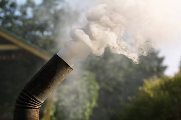 Russian samovar's tube with thick grey and white clouds of smoke, smoke from the chimney