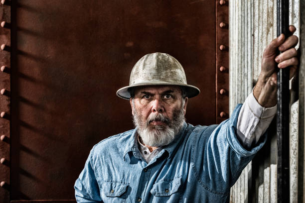 istock Middle-aged construction worker with stern look on job site 648209628