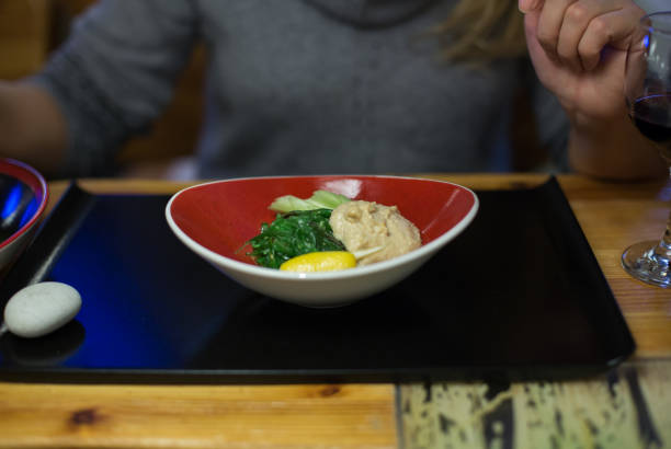 Woman arms take sushi and other japanese food