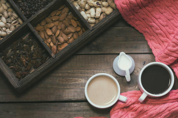 Cups of coffee on dark wooden background.