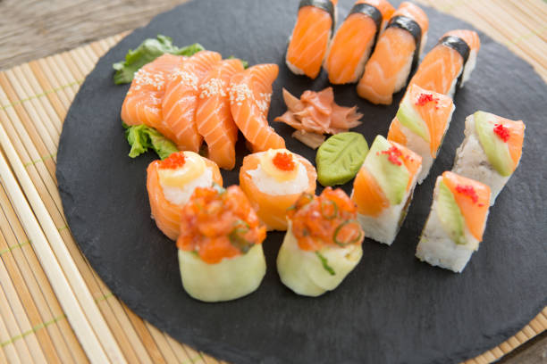 istock Slate tray of assorted sushi kept on mat 648226394