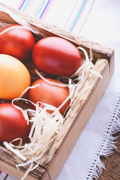 istock Easter painted red eggs in  wooden crate 648233924