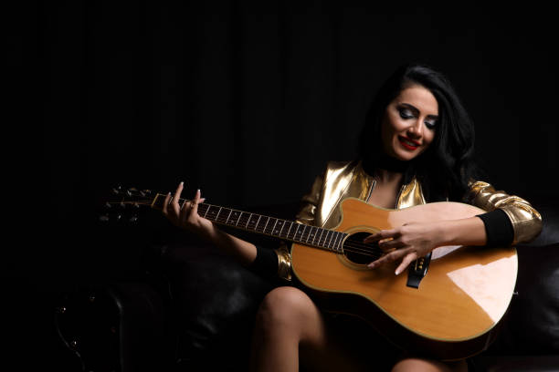 istock Beautiful Woman Playing Guitar 648239174