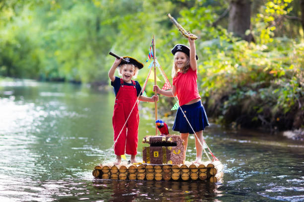 istock Kids playing pirate adventure on wooden raft 648239540