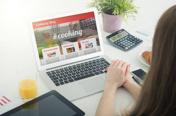 istock Woman using laptop in home. Culinary website blog concept 648242410