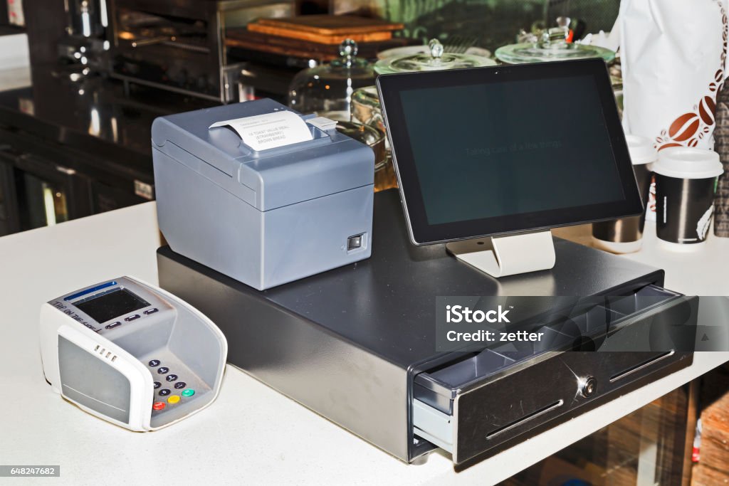 POS Tablet Screen Off Point of sales computer terminal with touch screen tablet, cash register, mobile printer and card payment on a counter at a coffee shop. Point Of Sale Stock Photo