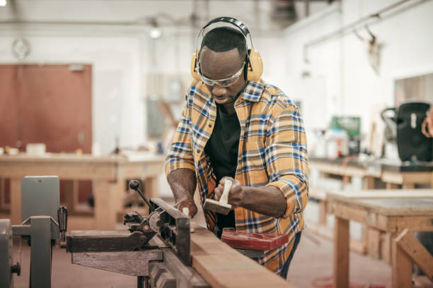 istock Male carpenter working with power tools in his wood shop 648248342