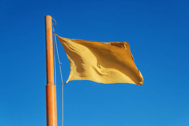 istock Yellow flag on a background of blue sky 648248622