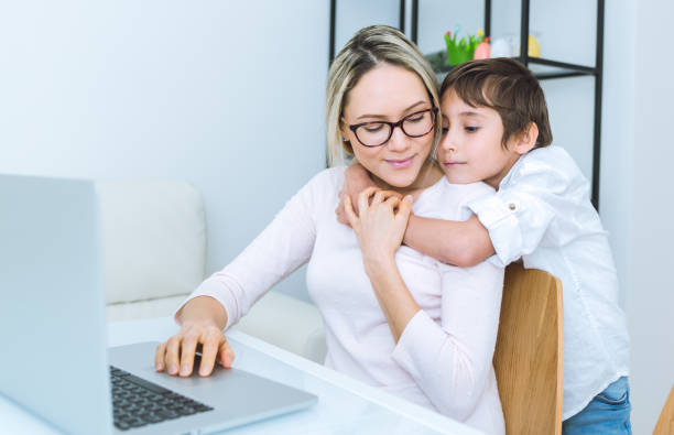 istock Mother and son working with a laptop 648249222