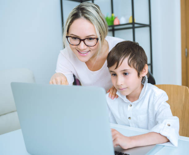 istock Mother and son working with a laptop 648249342