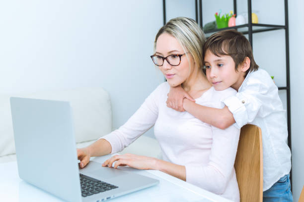 istock Mother and son working with a laptop 648249394