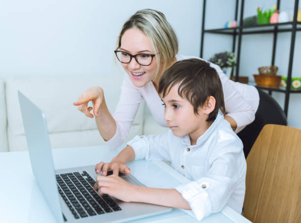 istock Mother and son working with a laptop 648249416