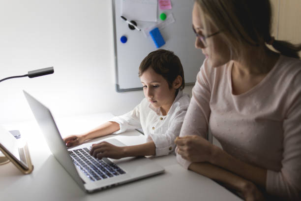 istock Mother and son working with a laptop 648251084