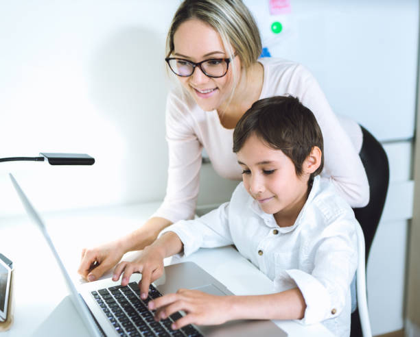istock Mother and son working with a laptop 648251472