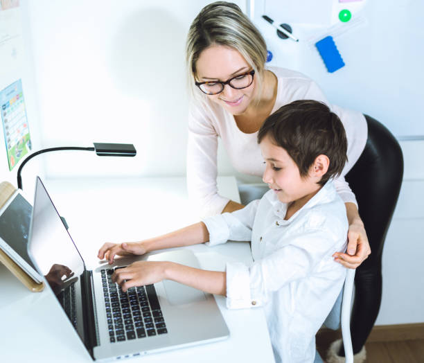 istock Mother and son working with a laptop 648251500